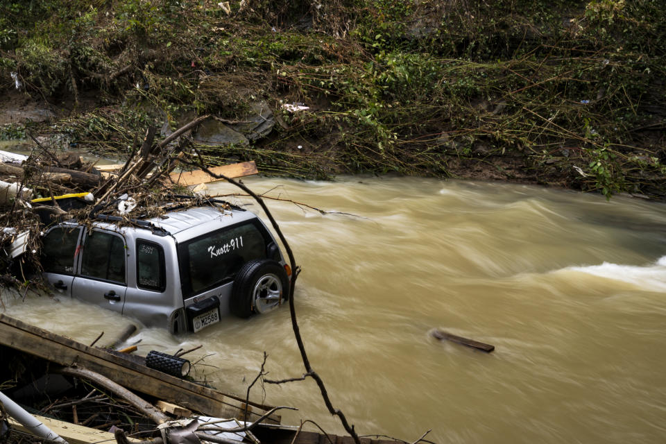 Image: A Knott County emergency vehicle gathers debris in the flooded Troublesome Creek in downtown Hindman, Ky. on Aug. 2, 2022. (Michael Swensen for NBC News)