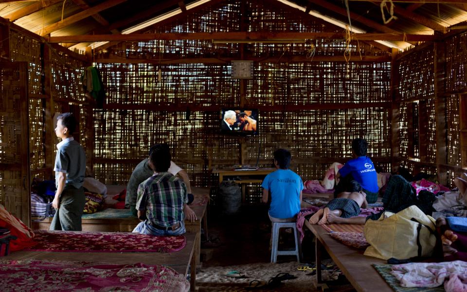 In this Jan 28 photo, young drug addicts watch television at a drug rehabilitation center run by the Kachin Baptist Community at Nampatka Village, Northern Shan State, Myanmar. Many residents said they are sick of seeing their community ripped apart by drugs, though growing opium is one of the few ways people can make money in impoverished rural areas of Myanmar such as this. In this village, roughly half the population uses heroin and opium. (AP Photo/Gemunu Amarasinghe)