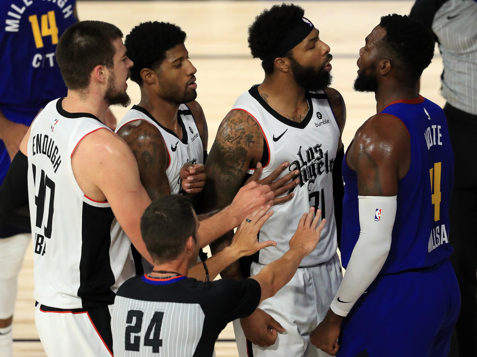 Marcus Morris Sr. #31 of the LA Clippers and Paul Millsap #4 of the Denver Nuggets get into a scuffle during the second quarter in Game Five of the Western Conference Second Round 