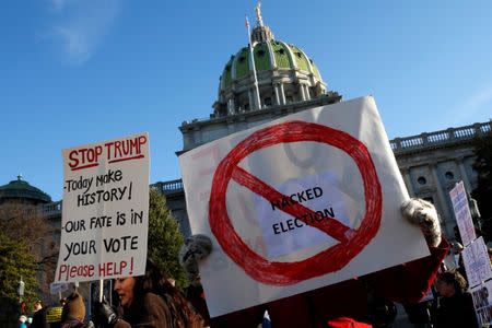 People protest against U.S. President-elect Donald Trump as electors gather to cast their votes for U.S. president at the Pennsylvania State Capitol in Harrisburg, Pennsylvania, U.S. December 19, 2016. REUTERS/Jonathan Ernst