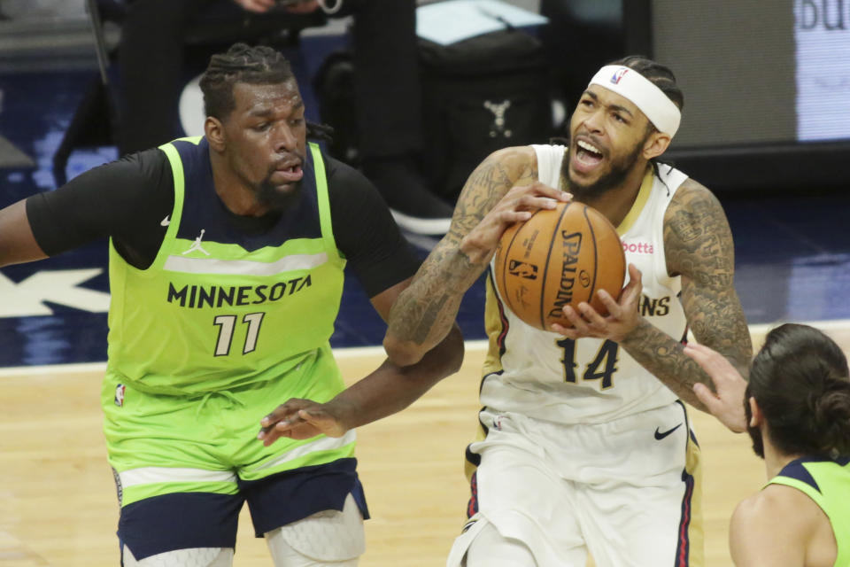 Minnesota Timberwolves center Naz Reid (11) defends against New Orleans Pelicans forward Brandon Ingram (14) in the second quarter during an NBA basketball game, Saturday, Jan. 23, 2021, in Minneapolis. (AP Photo/Andy Clayton-King)