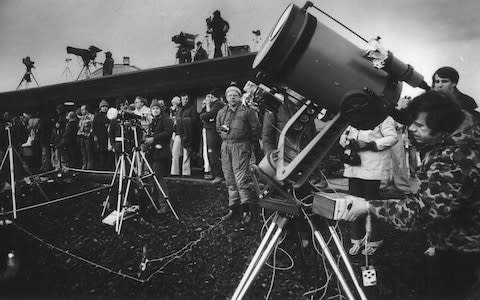 Eclipse enthusiasts, photographers and television crews gather to watch a solar eclipse in Washington, US, 1979.  - Credit: Randy Wood/The Oregonian via AP