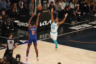 New York Knicks guard Immanuel Quickley (5), defended by Charlotte Hornets guard Ish Smith (14), shoots the ball during the first half of an NBA basketball game in New York, Sunday, Nov. 12, 2023. (AP Photo/Peter K. Afriyie)