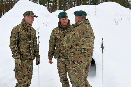 Britain's Prince Harry, Captain General Royal Marines, talks to British and Norwegian military personnel during Exercise Clockwork, celebrating 50 years of cold weather training of Commando Helicopter Force and Joint Helicopter Command at Bardufoss, Norway February 14, 2019. NTB Scanpix/Rune Stoltz Bertinussen via REUTERS
