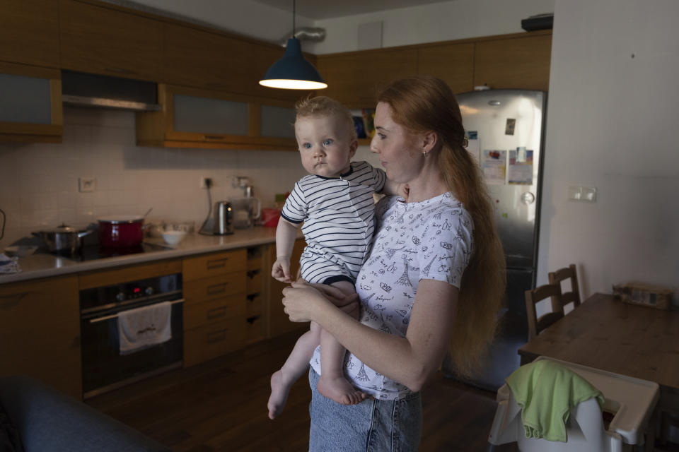 Taisiia Mokrozub, a Ukrainian refugee from Zaporizhzhia, holds her son Hordii during an interview with The Associated Press in a flat in Pruszkow, Poland, Wednesday, Aug. 17, 2022. (AP Photo/Michal Dyjuk)