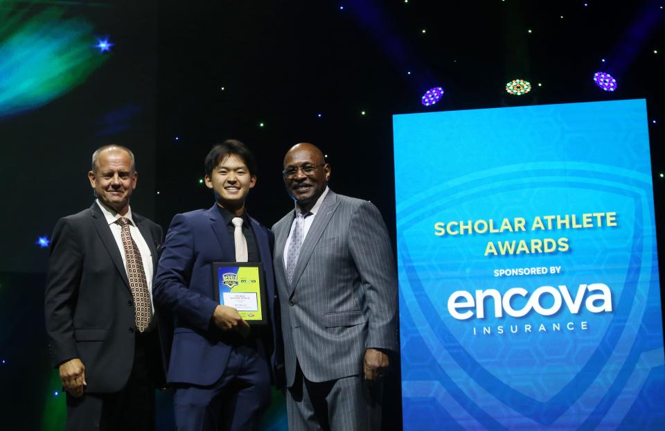 Dublin Jerome's Kevin Liu receives the Male Scholar Athlete of the Year award from John Kessler, Encova Insurance executive vice president and chief strategy officer, and Archie Griffin, two-time Heisman Trophy winner and Encova Insurance representative.