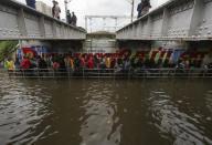 People make their way through a flooded underpass in Chennai, India, Wednesday, Nov.25, 2020. India’s southern state of Tamil Nadu is bracing for Cyclone Nivar that is expected to make landfall on Wednesday. The state authorities have issued an alert and asked people living in low-lying and flood-prone areas to move to safer places. (AP Photo/R. Parthibhan)