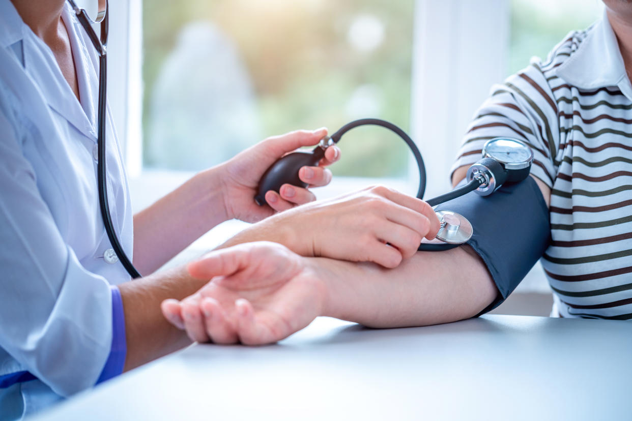 Doctor measures the pressure of the patient during a medical examination and consultation in the hospital.