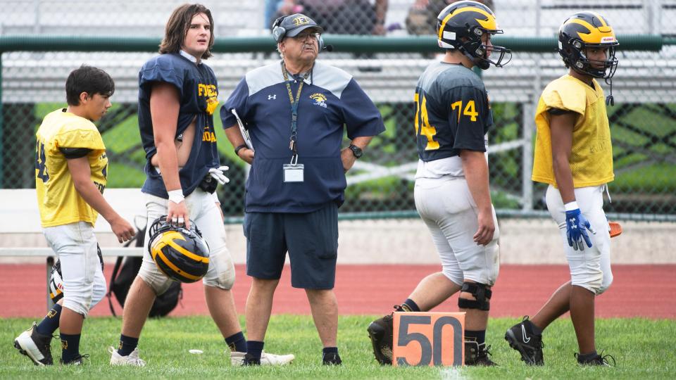 Florence High School football coach Joe Frappolli stands by his players as Florence hosts Overbrook in a scrimmage on Thursday, August 24, 2023. Frappolli is entering his 50th season coaching the Florence Flash.