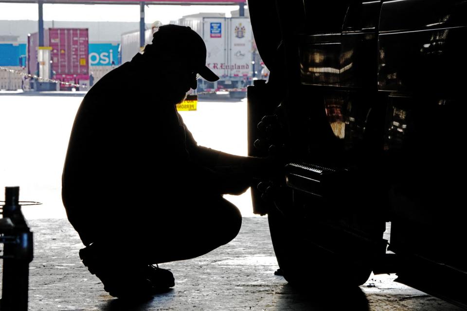 A mechanic checks out a semi-truck at the Love's Truck Stop in Springville, Utah, on December 1, 2021. - High fuel prices and a shortage of truckers have had a negative effect on the US supply chain. The US economy continues to struggle with supply issues that have pushed prices higher in recent weeks, but there are signs the strains may be easing, the Federal Reserve said on December 1. (Photo by GEORGE FREY / AFP) (Photo by GEORGE FREY/AFP via Getty Images)