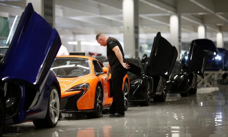 An employee inspects a McLaren 650S at the carmaker’s headquarters in Woking, Surrey