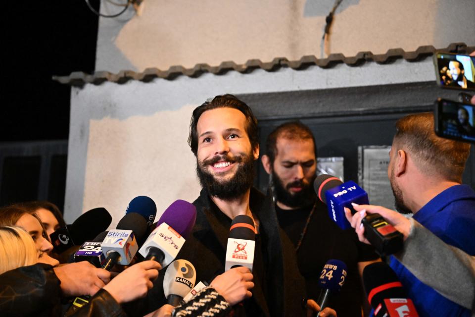 British-US former professional kickboxer and controversial influencer Andrew Tate (R) and his brother Tristan Tate (C-L) walk out of the central arrest centre of Bucharest police after three months of pre-trial detention, in Bucharest, on late March 31, 2023. - A Romanian court on March 31, 2023 ordered that controversial influencer Andrew Tate and his brother be moved from jail to house arrest while they are investigated for alleged human trafficking and rape. (Photo by Daniel MIHAILESCU / AFP) (Photo by DANIEL MIHAILESCU/AFP via Getty Images)