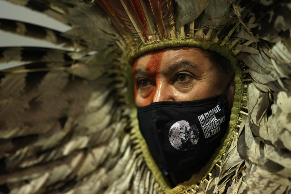 Indigenous Amazon delegate Romancil Gentil Kreta sits inside the venue of the COP26 U.N. Climate Summit in Glasgow, Scotland, Tuesday, Nov. 9, 2021. The U.N. climate summit in Glasgow has entered it's second week as leaders from around the world, are gathering in Scotland's biggest city, to lay out their vision for addressing the common challenge of global warming. (AP Photo/Alastair Grant)