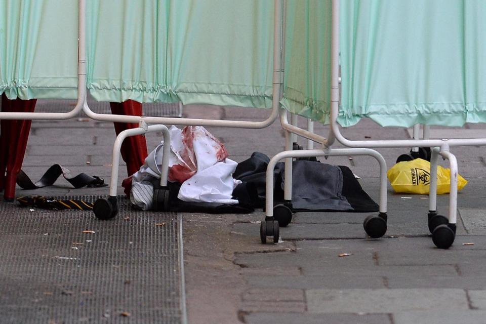 Bloody clothing at the scene outside Victoria Station in central London (PA)