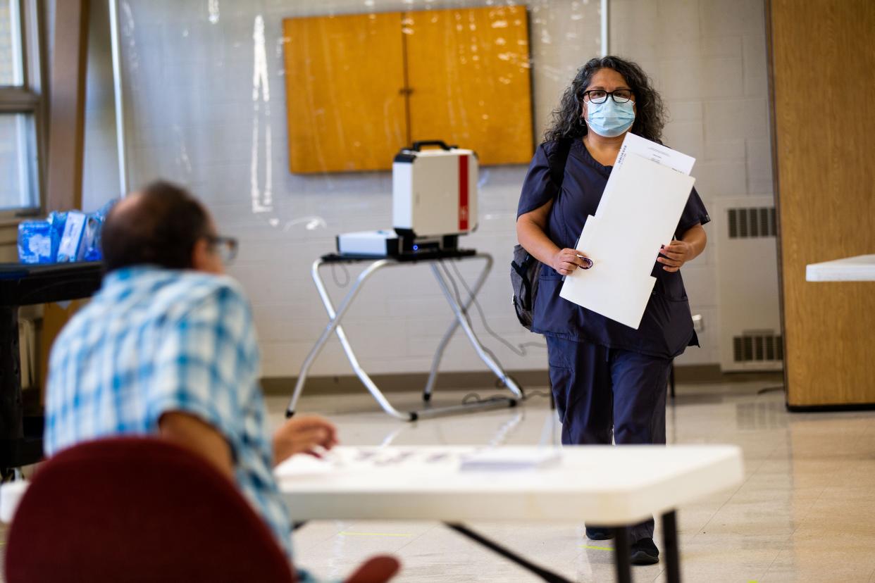 Voters turn in their primary election ballots Tuesday, Aug. 2, 2022, at Rose Park Reformed Church in Holland. 