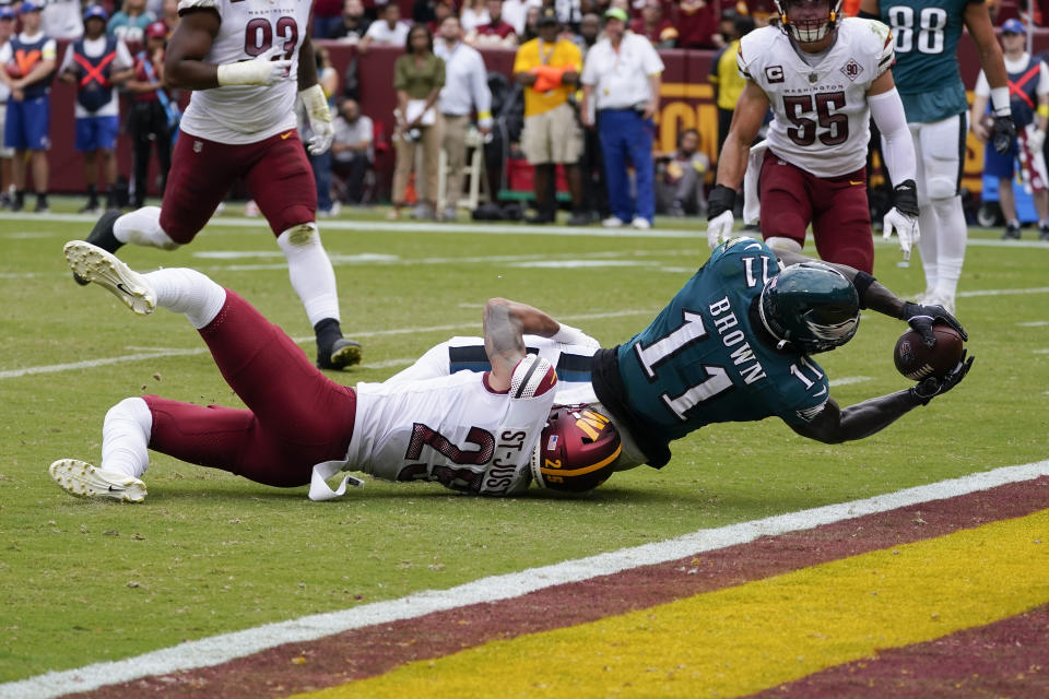 Philadelphia Eagles wide receiver A.J. Brown (11) scoring a touchdown against Washington Commanders cornerback Benjamin St-Juste (25) during the first half of an NFL football game, Sunday, Sept. 25, 2022, in Landover, Md. (AP Photo/Alex Brandon)