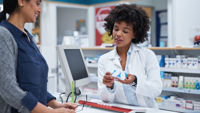 Shot of a pharmacist assisting a customer in a chemist.