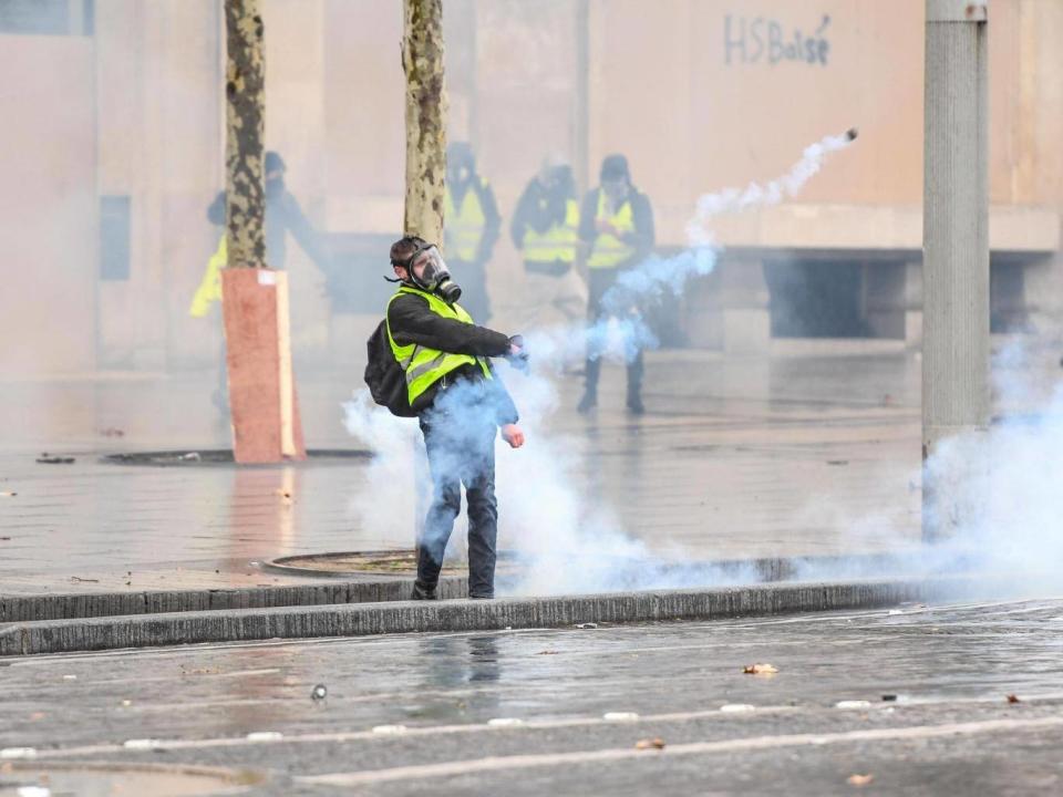 A protester stands on the Champs Elysees (Getty)