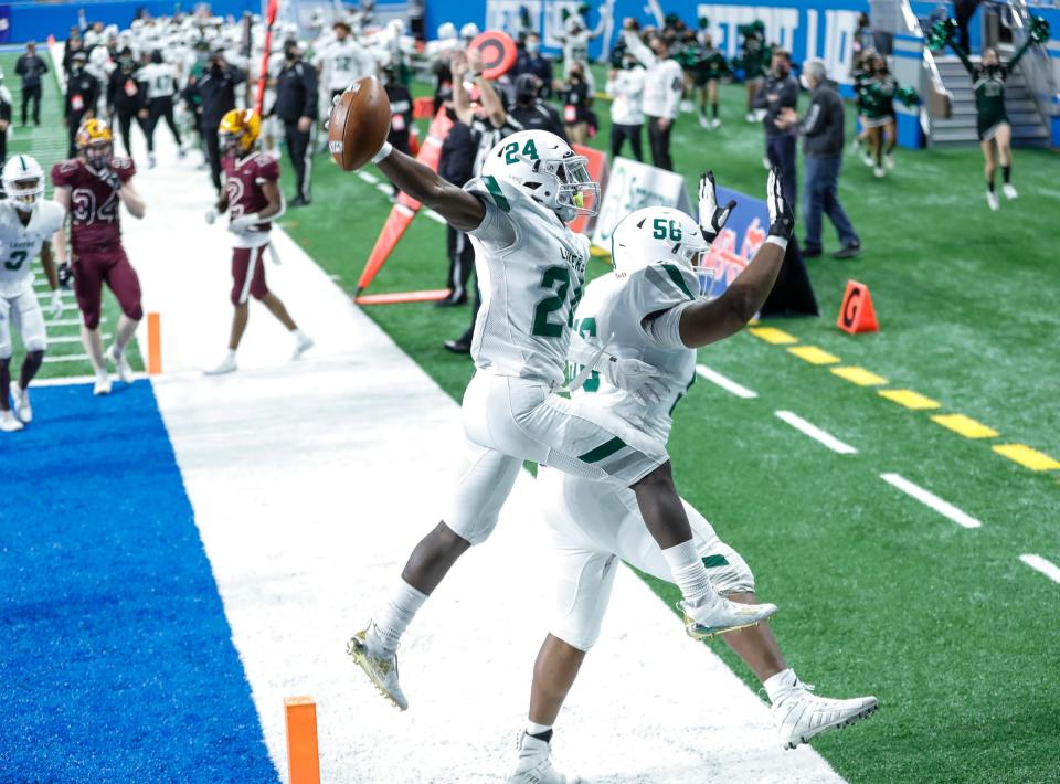 West Bloomfield running back Mekhi Elam (24) celebrates with offensive lineman Amir Herring after a touchdown against Davison during the first half of the MHSAA Division 1 final at Ford Field, Saturday, Jan. 23, 2021.