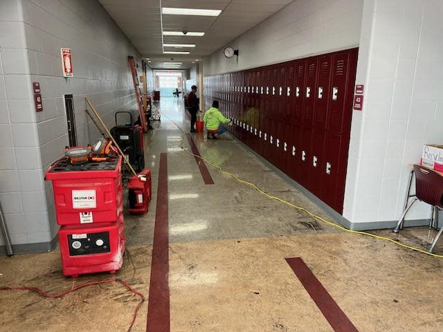 The hallway in Newark High School's F wing, where a small fire occurred Saturday in a classroom, continues to be cleaned by a professional company.