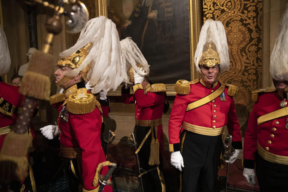 Members of the Honourable Corps of Gentlemen at Arms get ready to line-up in the Norman Porch at the Palace of Westminster and the Houses of Parliament at the State Opening of Parliament ceremony in London, Monday, Oct. 14, 2019. (AP Photo/Matt Dunham, Pool)