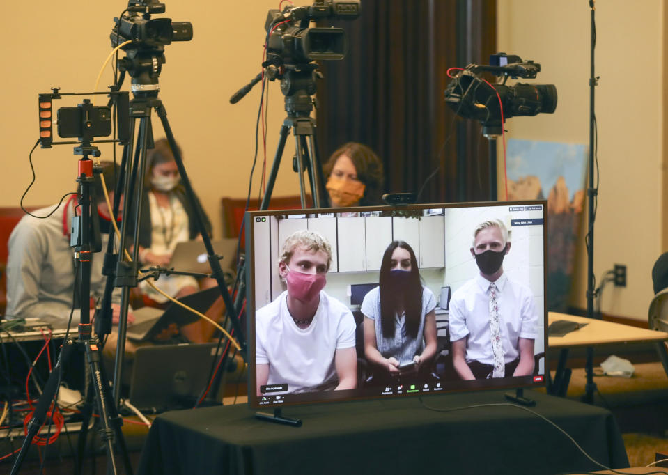 Enterprise High School seniors Broc Gardner, left, Dallee Cobb and Dawson Thelin participate virtually from their school in Enterprise, Washington County, during the weekly COVID-19 briefing at the Capitol in Salt Lake City on Wednesday, Aug. 26, 2020. The high school seniors who pushed back against recent anti-mask protests joined Gov. Gary Herbert at a weekly briefing imploring parents to stop fighting Utah's face covering mandate in schools. (Steve Griffin/Deseret News via AP, Pool)