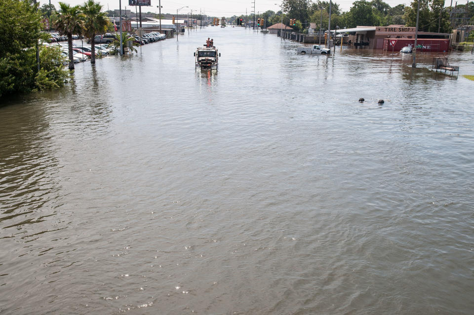 A large truck transporting&nbsp;rescue crews drives through the flooded streets of Port Arthur.