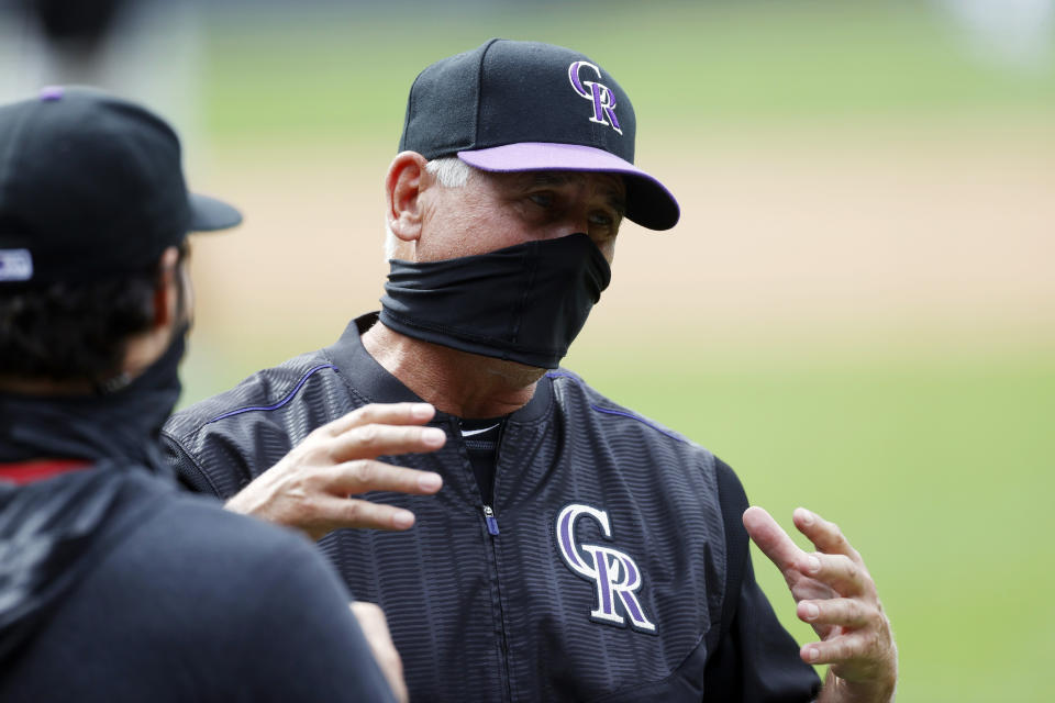 Colorado Rockies manager Bud Black, right, confers with third baseman Nolan Arenado who takes part in drills during the team's baseball practice Sunday, July 12, 2020, in Denver. (AP Photo/David Zalubowski)