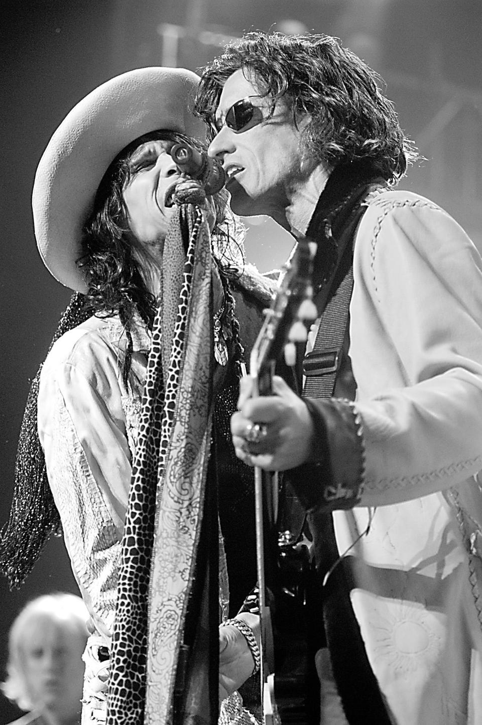 Aerosmith's Steven Tyler, left, is a part-time resident of Marshfield and guitarist Joe Perry, lived in Duxbury for many years. They are shown in this Aug. 25, 2003, file photo performing a concert at the Tweeter Center.