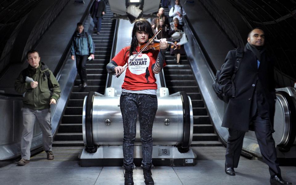 "Underground sounds: travellers are treated to a recital at Waterloo station, London - BEN STANSALL/AFP