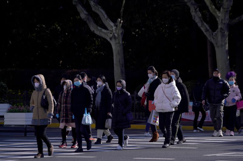 FILE PHOTO: People wear face masks as a protection from coronavirus in Shanghai