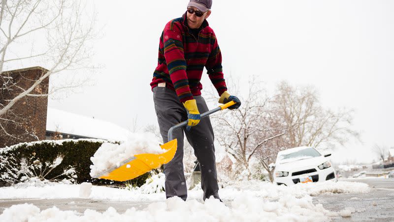 David Usher shovels snow in Salt Lake City on Friday. Utah’s valleys may receive another inch or two this week, while the mountains may end up with another foot from the latest storm arriving in Utah.