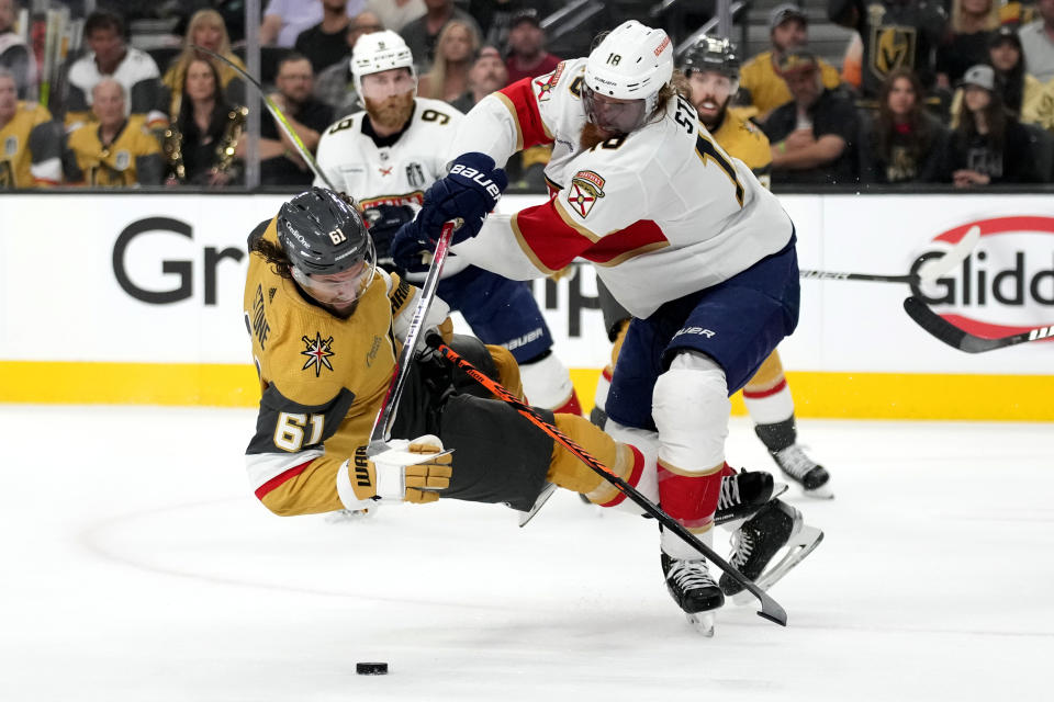 Florida Panthers defenseman Marc Staal (18) checks Vegas Golden Knights right wing Mark Stone (61) during the second period of Game 1 of the NHL hockey Stanley Cup Finals, Saturday, June 3, 2023, in Las Vegas. (AP Photo/John Locher)