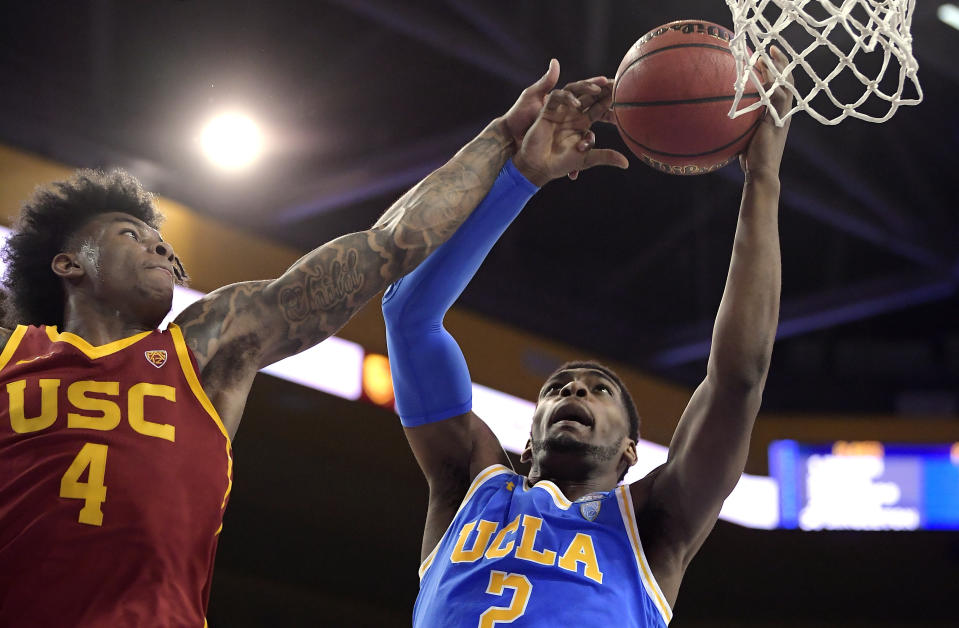 FILE - In this Feb. 28, 2019, file photo, UCLA forward Cody Riley, right, grabs a rebound away from Southern California guard Kevin Porter Jr. during the first half of an NCAA college basketball game in Los Angeles. The NCAA’s Board of Governors is urging Gov. Gavin Newsom not to sign a California bill that would allow college athletes to receive money for their names, likenesses or images. In a six-paragraph letter to Newsom, the board said the bill would give California schools an unfair recruiting advantage. As a result, the letter says, the NCAA would declare those schools ineligible for its events. (AP Photo/Mark J. Terrill, File)