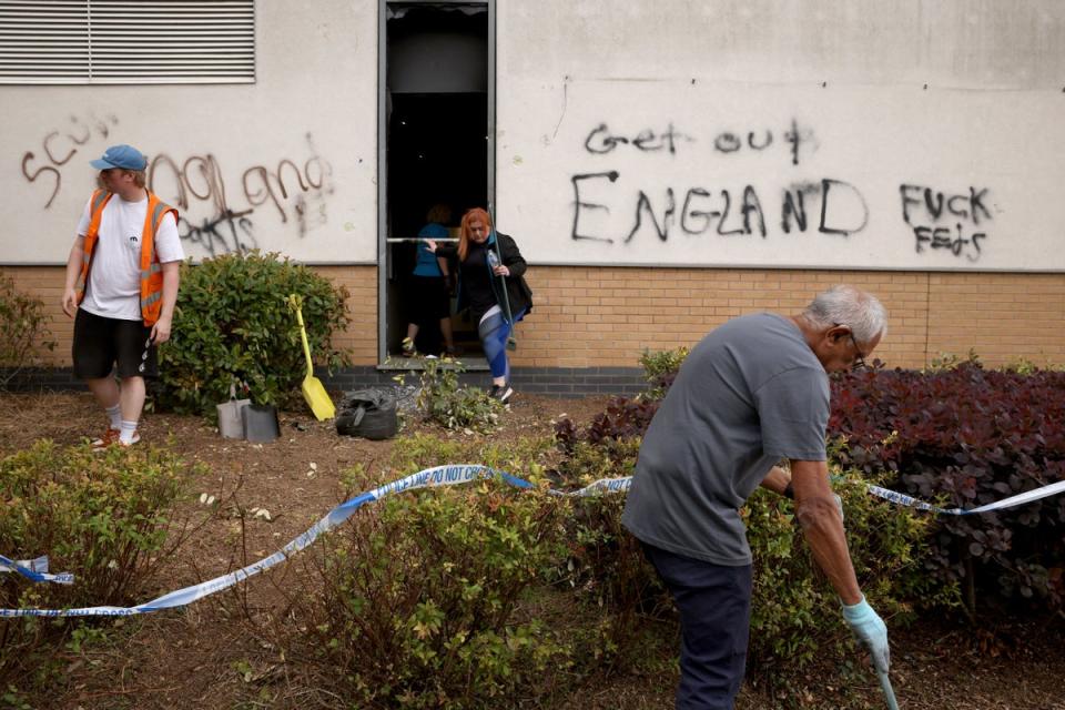 Locals clear debris outside a Holiday Inn Express in Tamworth, Staffordshire (Getty)