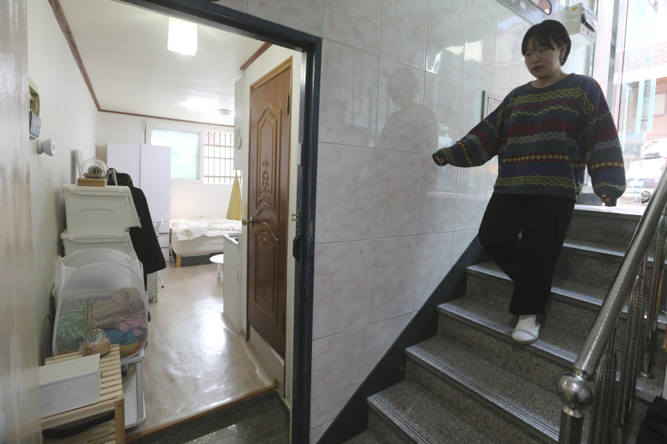 Kim Da-hye, a 29-year-old South Korean, comes down the stairs to enter her semi-basement apartment in Seoul, South Korea, Saturday, Feb. 15, 2020. For many South Koreans, the image of a cramped basement apartment portrayed in the Oscar-winning film “Parasite” rings true, bringing differences in their social status to worldwide attention. (AP Photo/Ahn Young-joon)