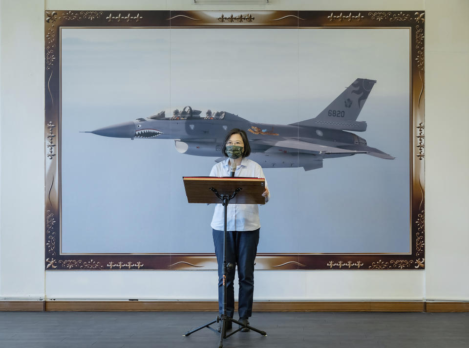 In this photo released by the Taiwan Presidential Office, Taiwan's President Tsai Ing-wen speaks in front of a picture of a Taiwanese F16 fighter jet at an airbase in Hualien in eastern Taiwan on Tuesday, Sept. 6, 2022. Taiwanese President Tsai Ing-wen said Tuesday that China is conducting "cognitive warfare" by spreading misinformation in addition to its regular incursions into nearby waters and airspace intended at intimidating the self-governing island. (Taiwan Presidential Office via AP)