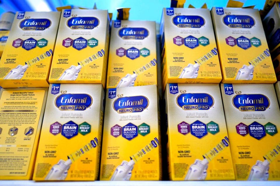 Infant formula is stacked on a table during a baby formula drive to help with the shortage May 14, 2022, in Houston.