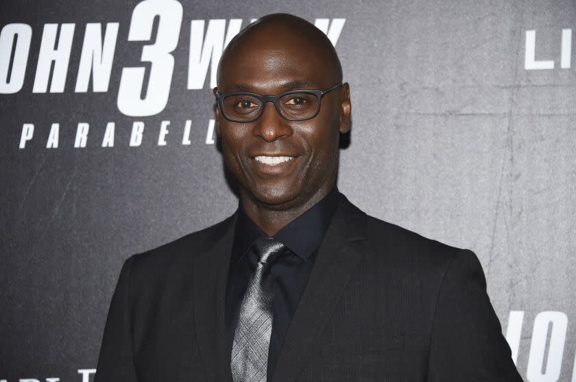 Actors Lance Reddick smiles at a movie premiere