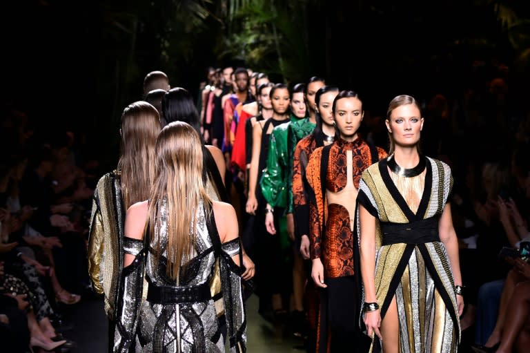 Models present creations for Balmain during the 2017 Spring/Summer ready-to-wear collection fashion show in Paris on September 29, 2016