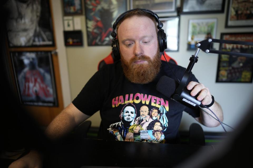 Brent Terhune poses for a portrait in his home podcasting studio in Greenwood, Ind.