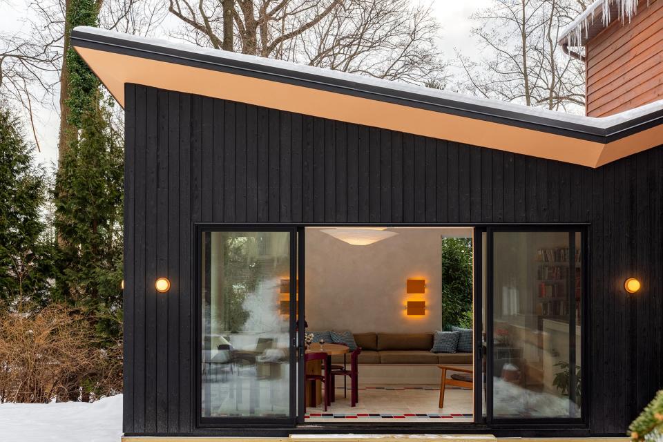 Dark exterior of home with sliding glass door