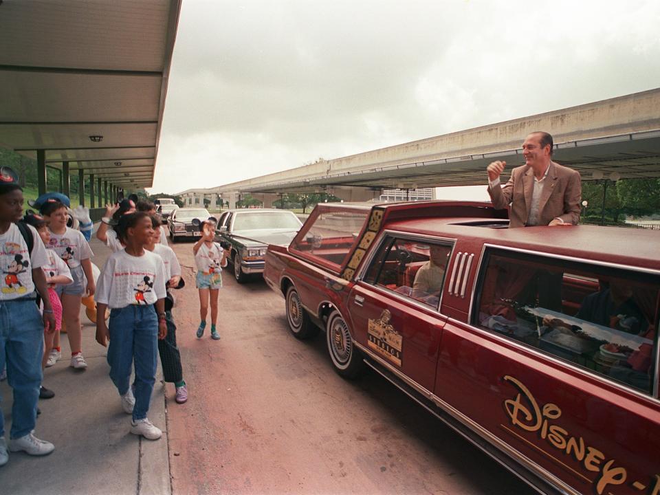 Paris Mayor Jacques Chirac (R) waves to a group of French children 06 May 1989