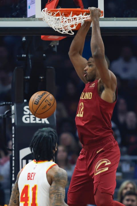 Cleveland Cavaliers center Tristan Thompson (12) dunks next to Atlanta Hawks forward Saddiq Bey (41) during the first half of an NBA basketball game Saturday, Dec. 16, 2023, in Cleveland. (AP Photo/Ron Schwane)