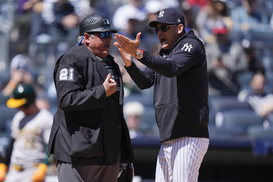 New York Yankees manager Aaron Boone, right, argues with umpire Hunter Wendelstedt during the first inning of the baseball game against the Oakland Athletics at Yankee Stadium Monday, April 22, 2024, in New York. Boone was ejected from the game. (AP Photo/Seth Wenig)