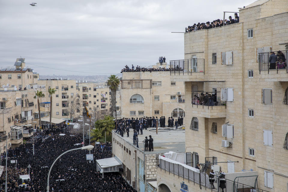 Thousands of ultra-Orthodox Jews participate in the funeral of prominent rabbi Meshulam Soloveitchik, flouting the country’s ban on large public gatherings amid the pandemic, in Jerusalem, Sunday, Jan. 31, 2021. (AP Photo/Ariel Schalit)