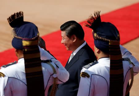 China's President Xi Jinping walks after inspecting his guard of honour during his ceremonial reception at the forecourt of India's Rashtrapati Bhavan presidential palace in New Delhi September 18, 2014. REUTERS/Ahmad Masood