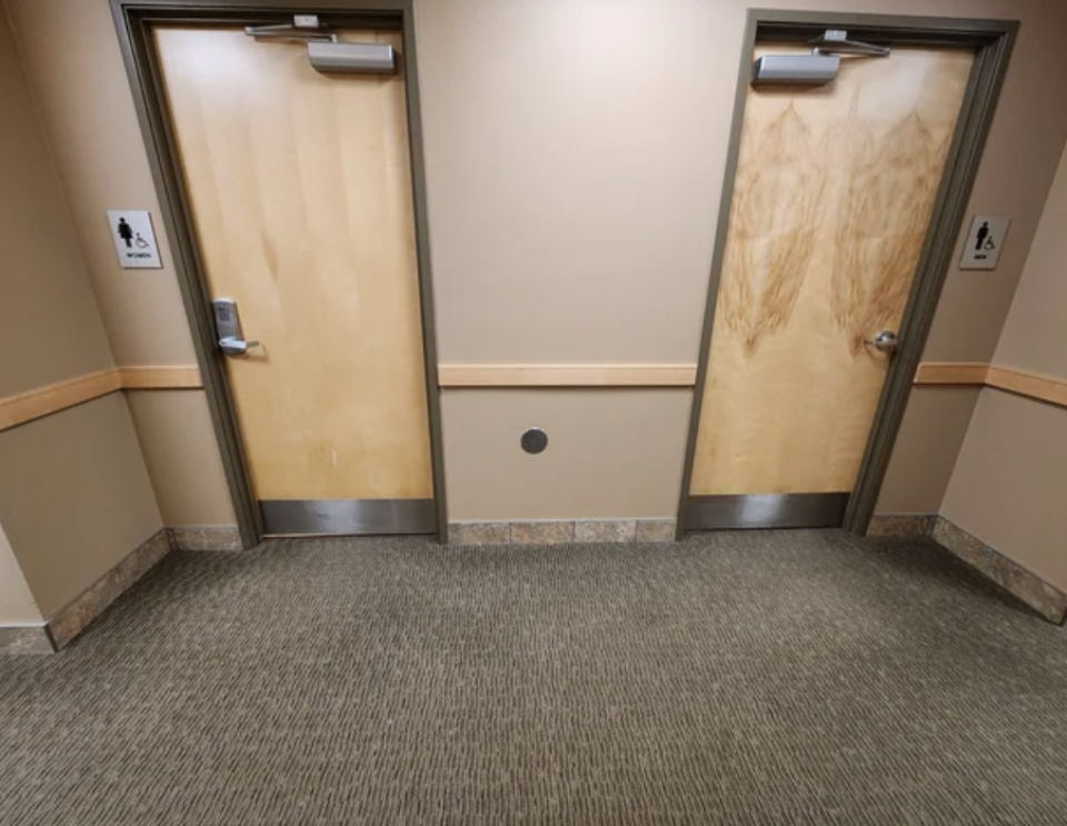 the gendered bathrooms in the hallway with a code lock on the women's door
