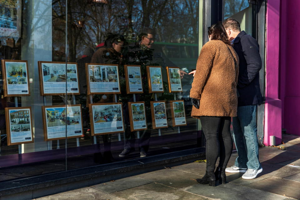Cost of living People look at properties on display in the window of Winkworth estate agents in Islington, London, Britain, December 10, 2021. Picture taken December 10, 2021. REUTERS/May James