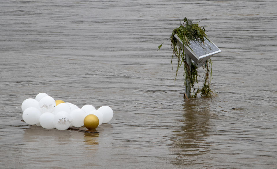 Debris floats down the Nepean River at Jamisontown on the western outskirts of Sydney, Monday, March 22, 2021. Australia's most populous state of New South Wales has issued more evacuation orders following the worst flooding in decades. (AP Photo/Mark Baker)